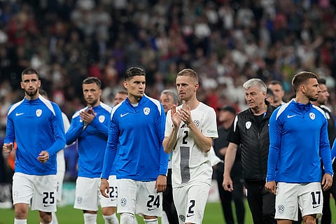 Slovenia's players react at the end of match against Portugal